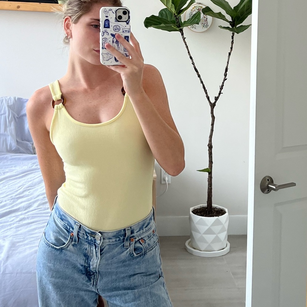 butter yellow ribbed bodysuit with ring details on sleeve